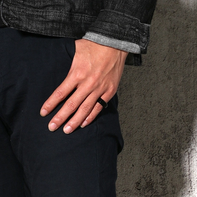 Black stainless steel gothic ring worn on male model's left ring finger, casual daily wear styling on skin