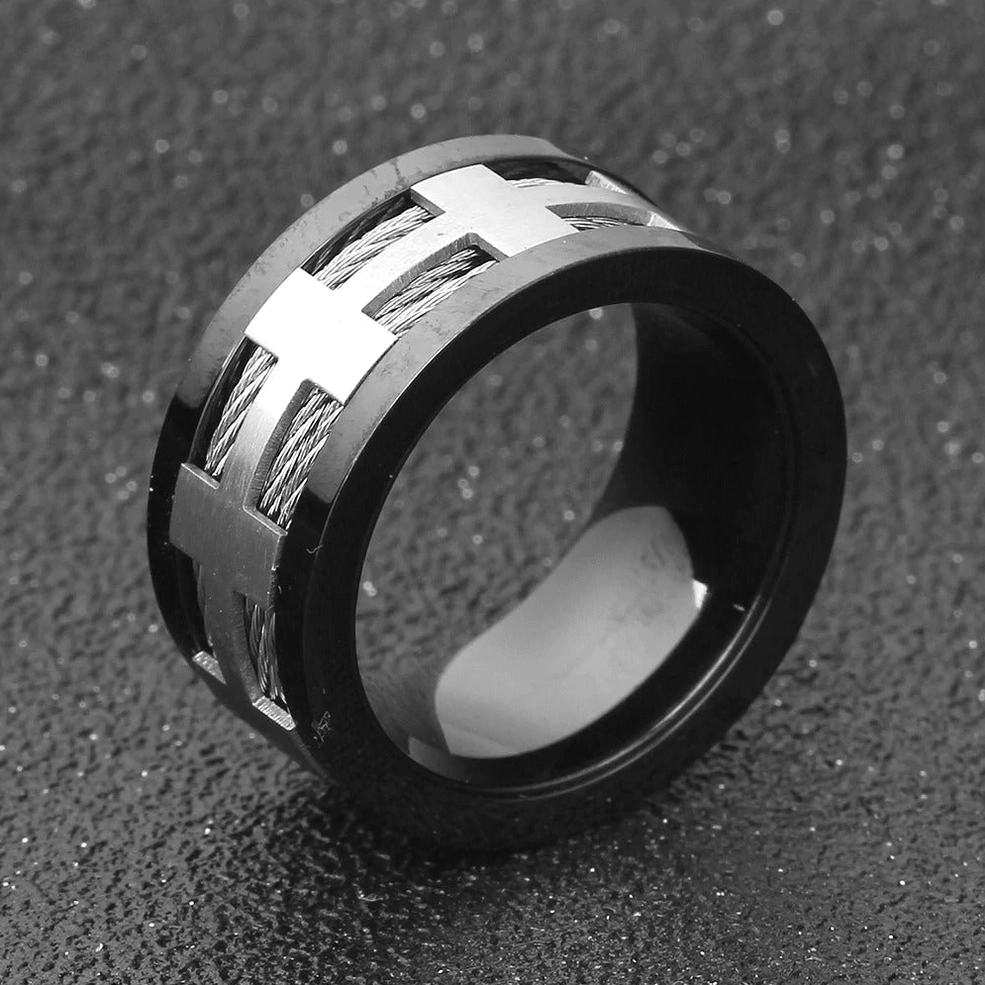 Side oblique angle of punk stainless steel gothic ring with silver cross accents and braided details on dark background
