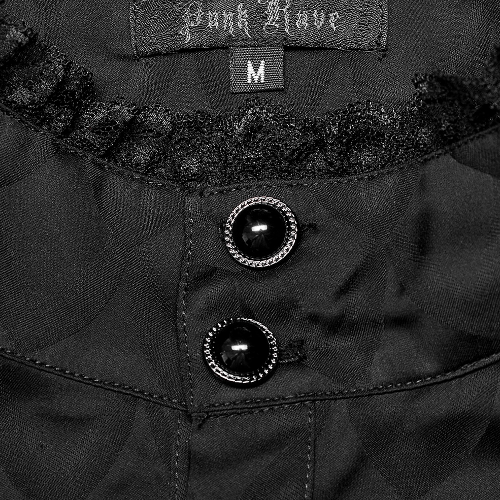 Close-up neckline detail of black gothic shirt showing ruffled lace collar and ornate gem buttons
