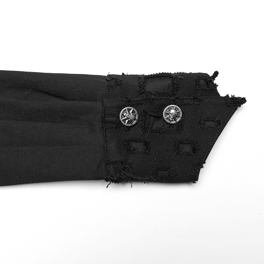 Close-up detail of black gothic shirt cuff with frayed distressed edges, metal star buttons, and cutout fabric texture