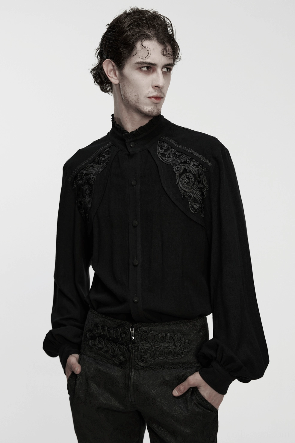 Black gothic shirt embroidery and fabric detail showing fine needle work, tonal embellishments, and woven textile quality