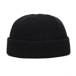 Black ribbed knit gothic skull beanie with folded brim - front flat lay view showing classic dark textile