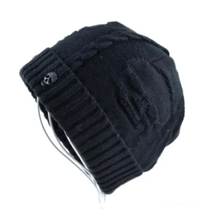 Black rolled-cuff gothic skull beanie featuring embossed skull pattern and metal skull tag - side angle view