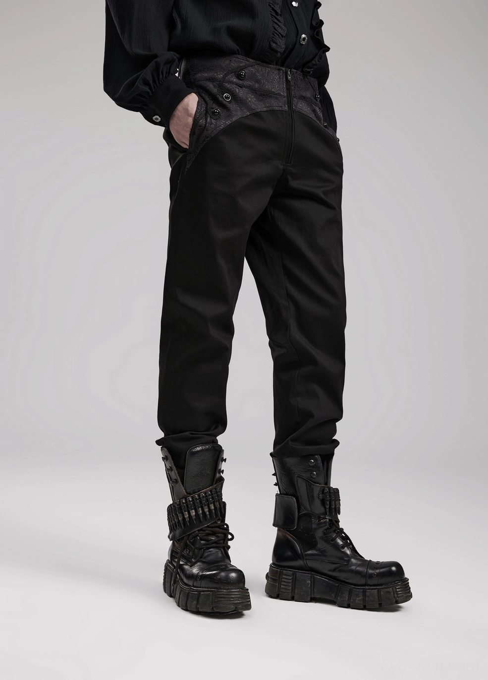 Full-length view of black gothic slim-fit trousers demonstrating complete structural tailoring and hem construction