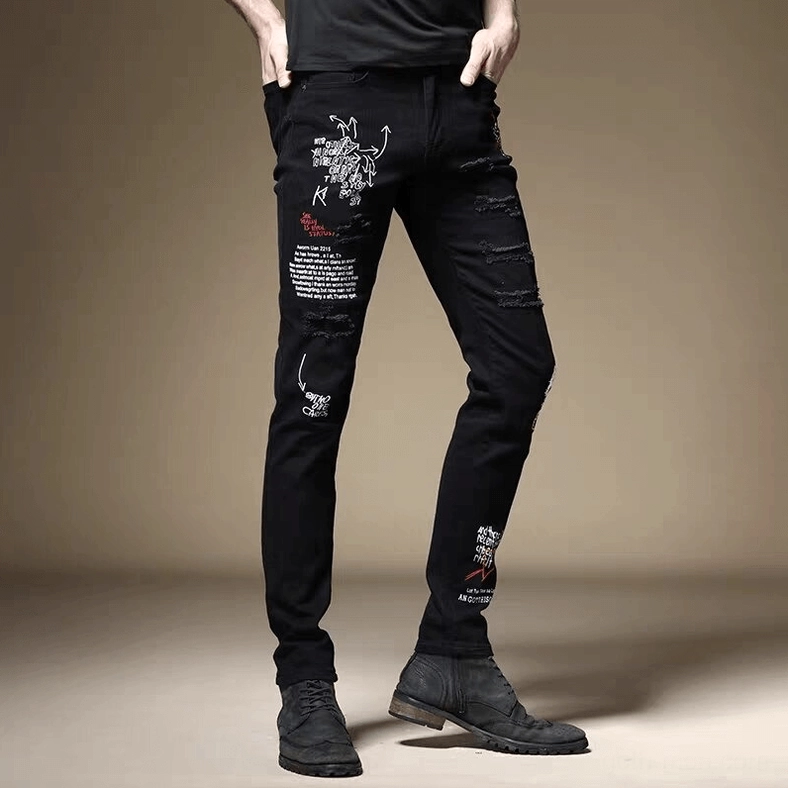 Black gothic slim ripped jeans front side view with graffiti letter prints and distressed details