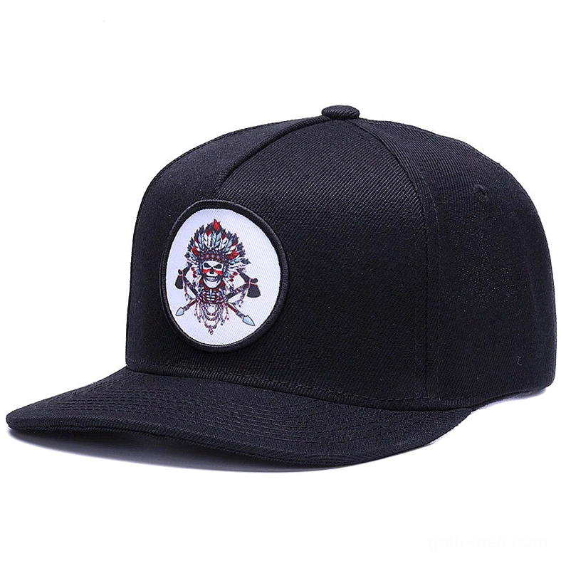 Black gothic snapback baseball cap with embroidered native skull motif, front three-quarter angle view showcasing round skull patch design