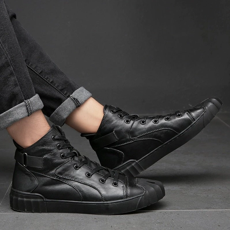 Pair of black leather high-top gothic sneakers displaying reinforced heel strap and lace-up design detail