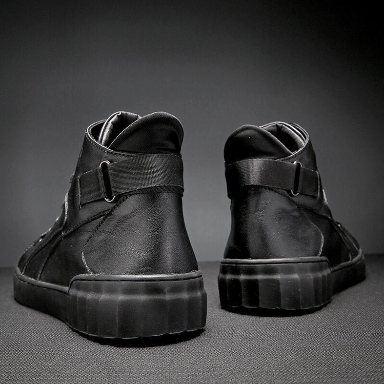 Rear perspective of black leather high-top sneakers highlighting padded ankle collar and heel strap