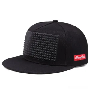 Black gothic spike snapback baseball cap with pyramid plastic studs, flat-brimmed design, three-quarter view showcasing spike detailing