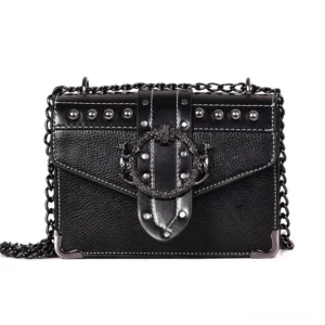 Black gothic square shoulder bag with skull rivet embellishments and ornate metal lock clasp, front view flat lay