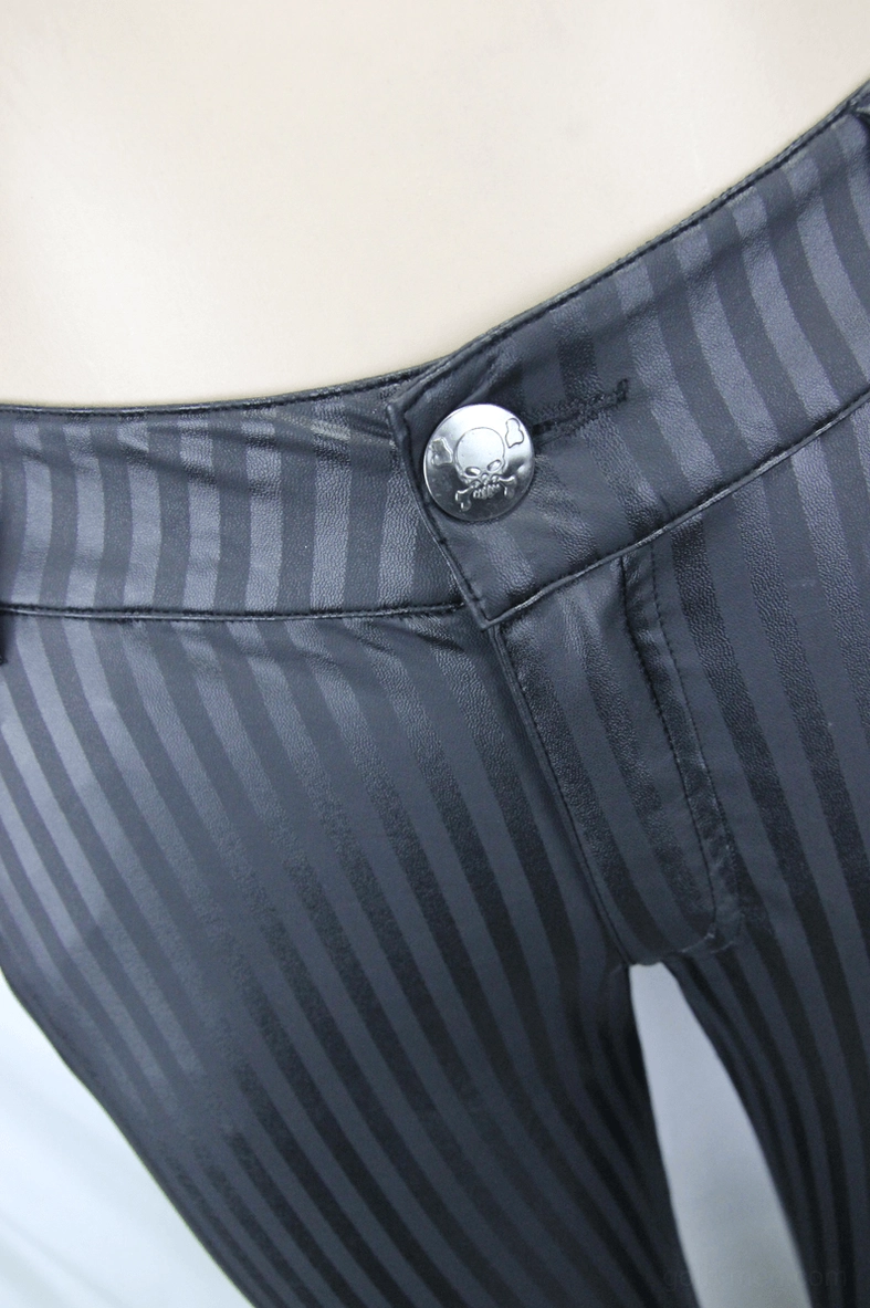 Close-up detail of skull button and vertical stripe waistband on gothic trousers