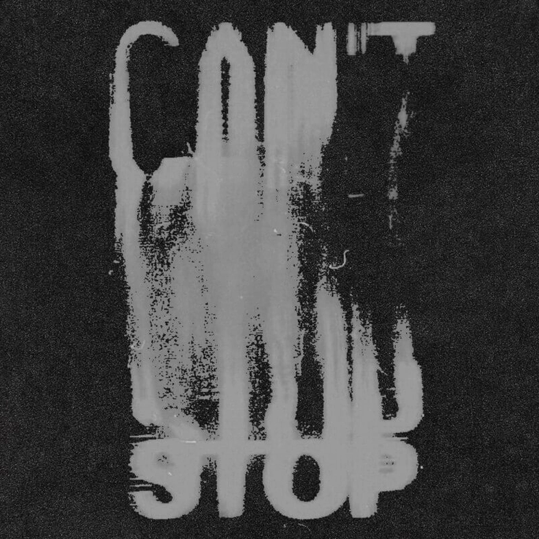Macro close-up of distressed grey letter print on black gothic tank top showing ink-wash vintage aesthetic