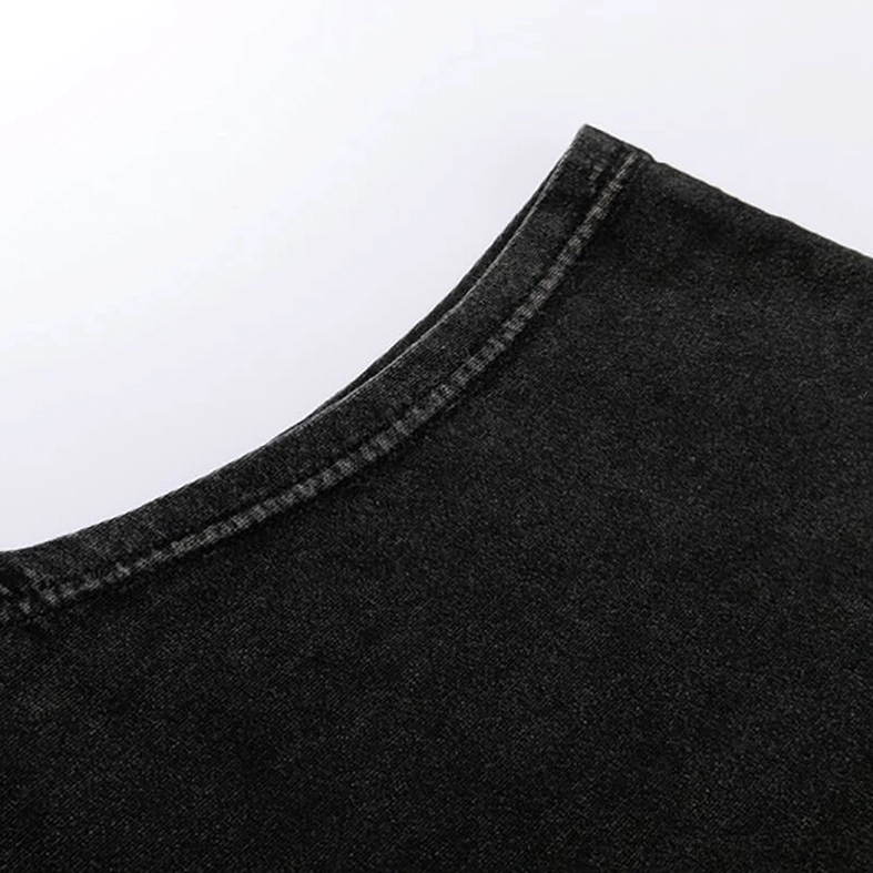 Shoulder seam close-up of black gothic tank top displaying overlock stitching and washed cotton texture