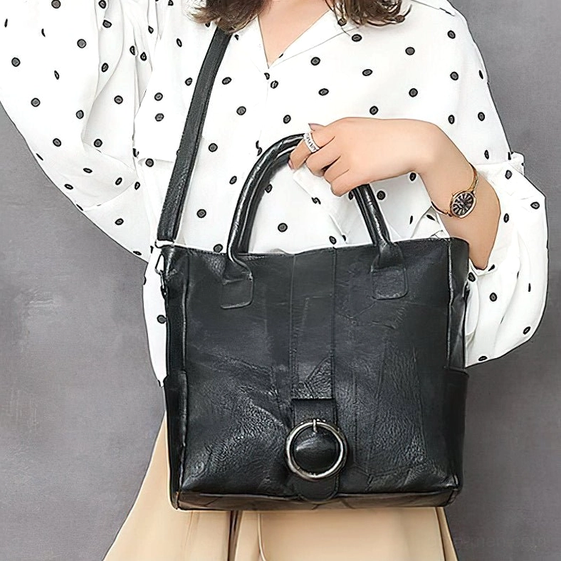 Woman carrying black gothic vintage leather tote - front wear perspective daily casual outfit
