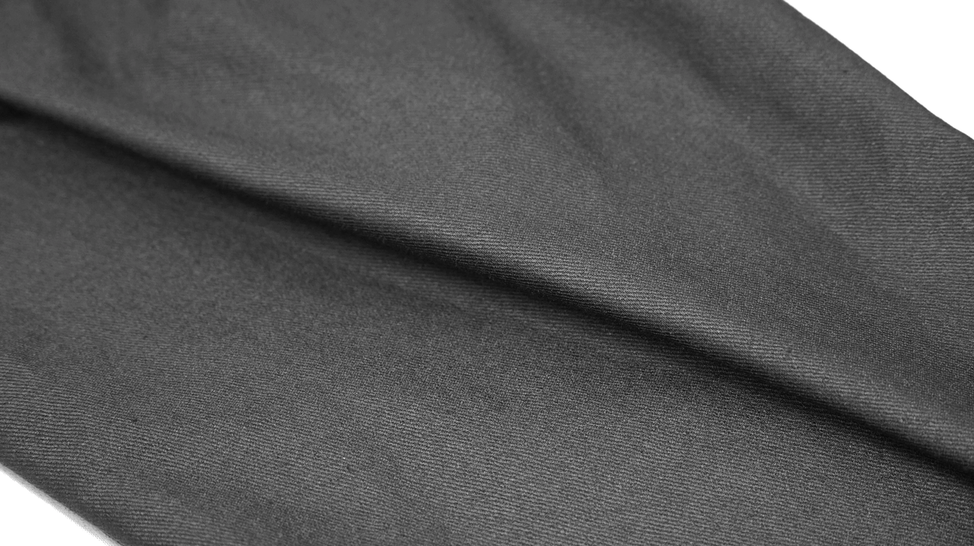 Matte woven textile fabric close-up showing black gothic trouser material quality