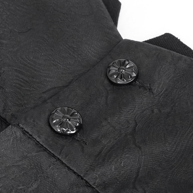 Black gothic trousers button closure detail showing matte finish and sculptural floral carving