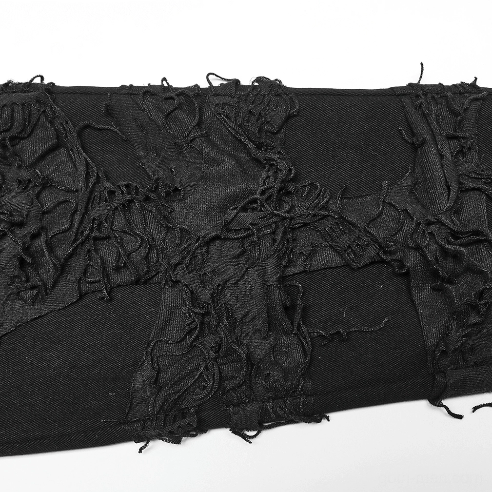 Close-up of black distressed knit fabric showing thick torn threads and fraying detail