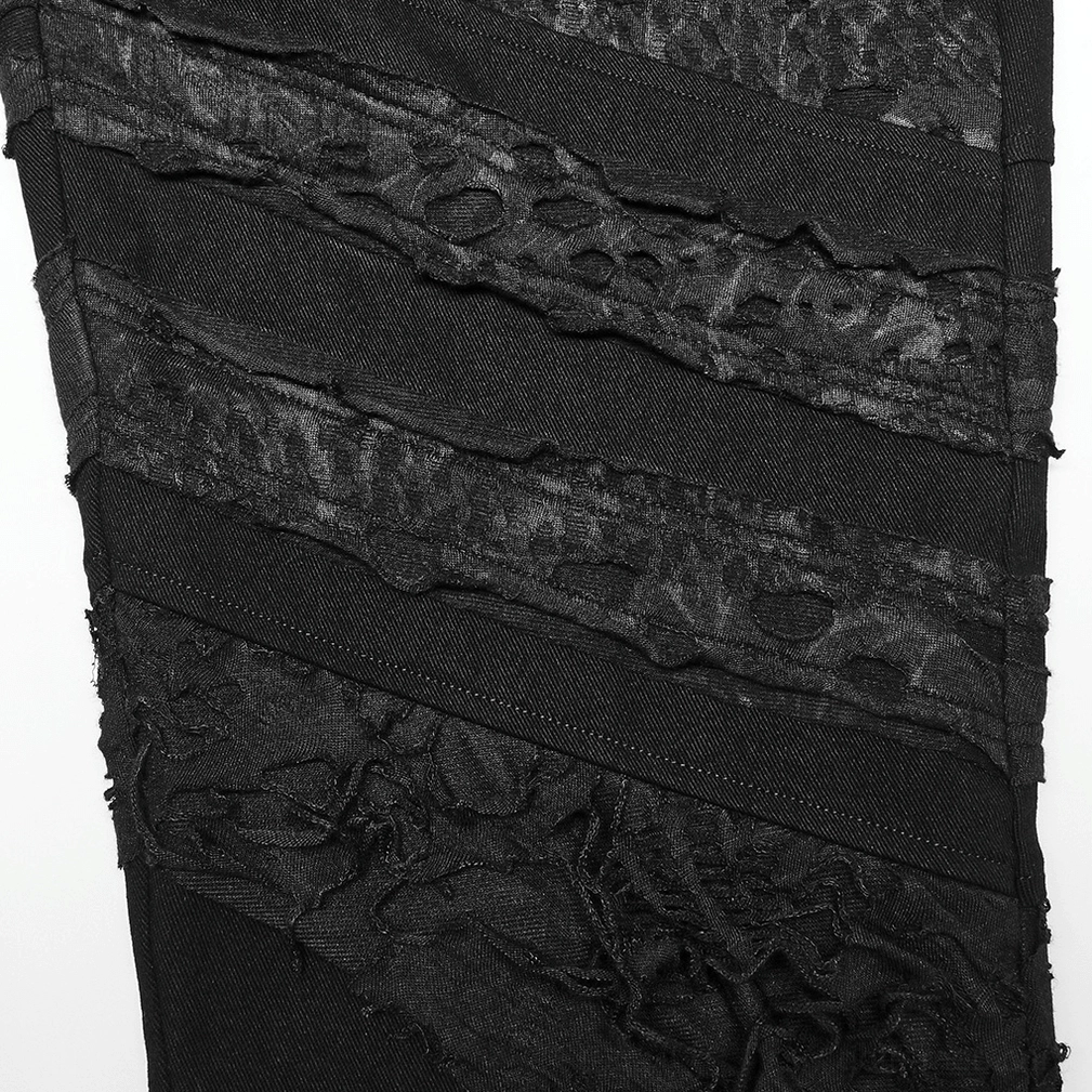 Black distressed gothic trousers close-up of striped perforated fabric texture