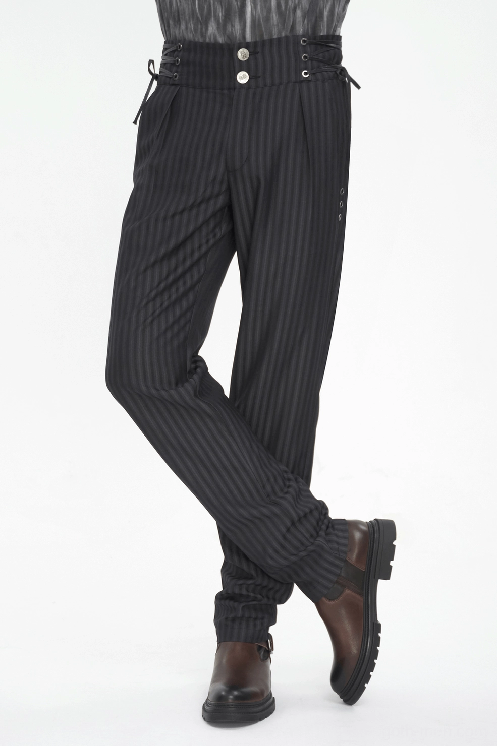Detailed view of lace-up side construction and metal hardware on black pinstriped gothic trousers