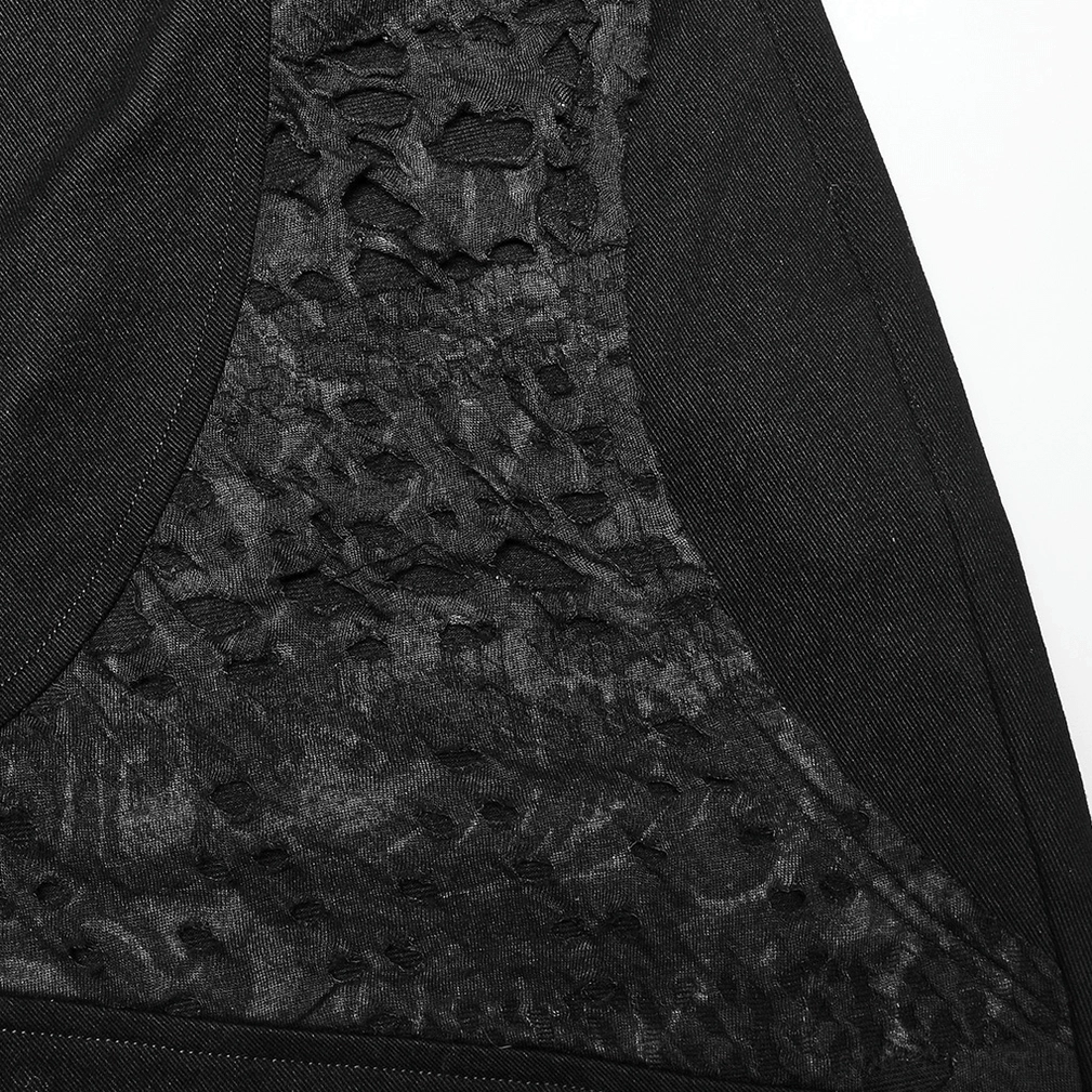 Black distressed gothic trousers close-up showing perforated woven fabric pattern