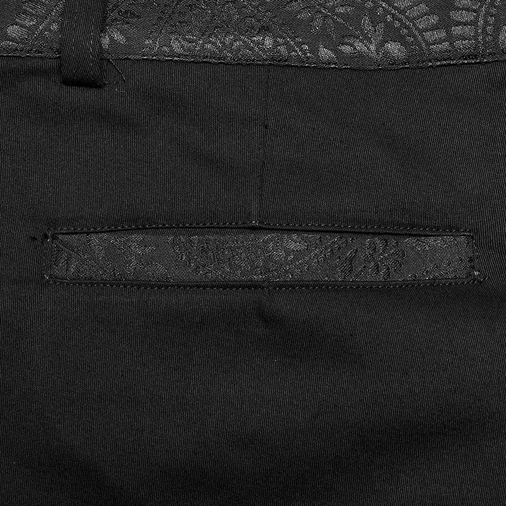 Close-up of black gothic trousers waist zipper and jacquard waistband with tailored seam detail