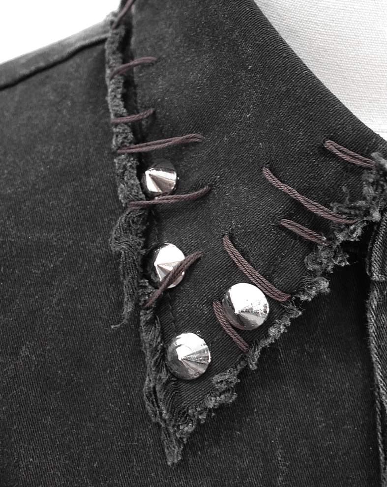 Close-up of pyramid metal studs and frayed collar edge on black gothic denim vest