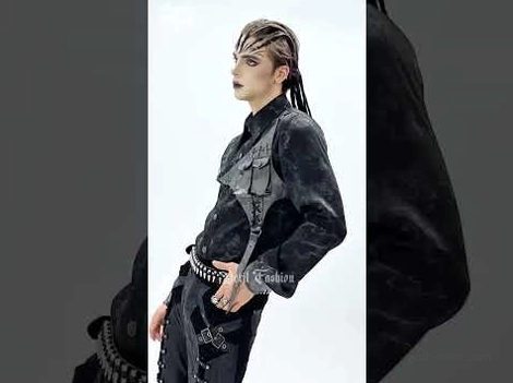 Side profile of male model wearing asymmetrical PU harness gothic button-up shirt with marbled black fabric