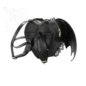 Black leather heart backpack rear three-quarter angle showcasing gold metal zippers, lace details, and adjustable straps with spider web background