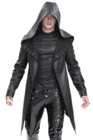 Front view of black asymmetrical hooded gothic coat with metal eyelets worn by male model in studio