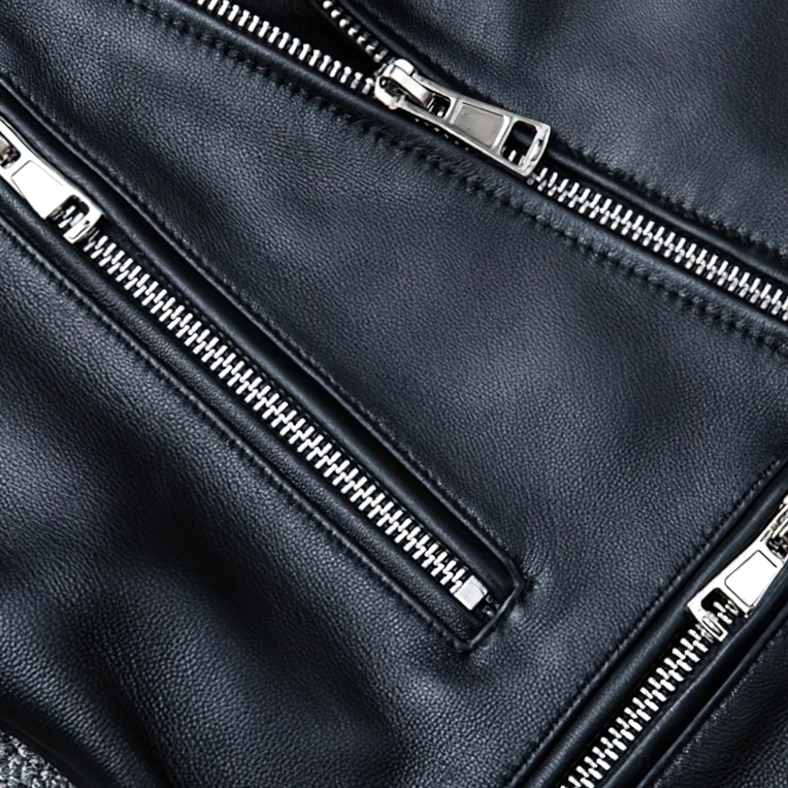 Multiple silver metal zippers on black leather jacket with neat precision stitching and hardware