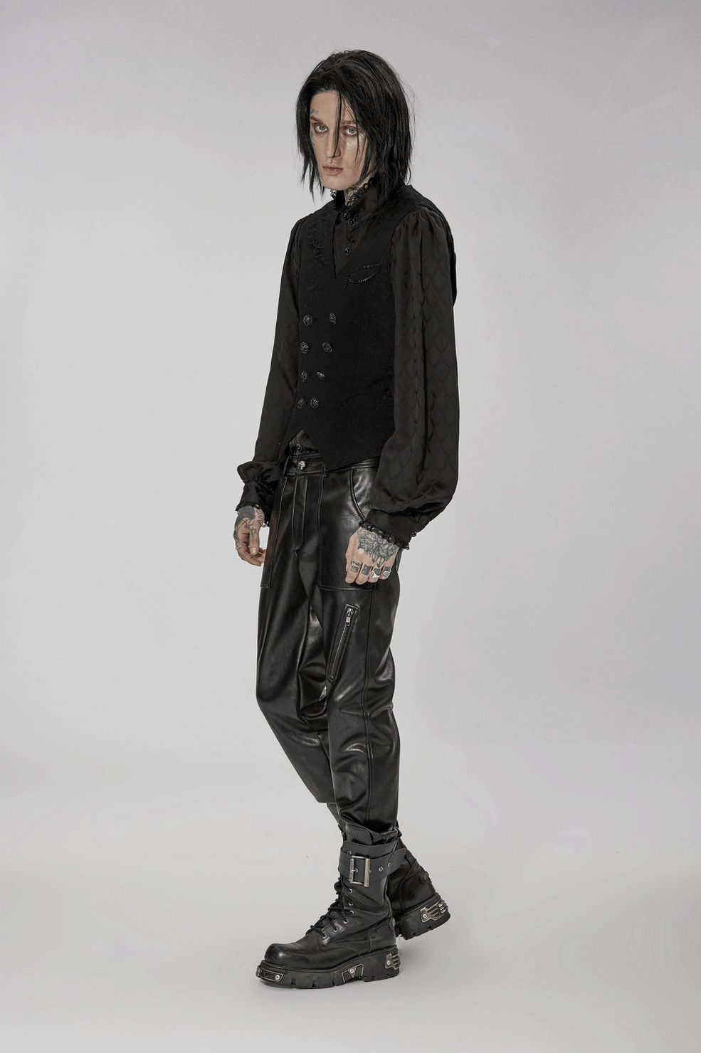 Full-length view of black jacquard gothic waistcoat layered outfit styling on model against neutral backdrop