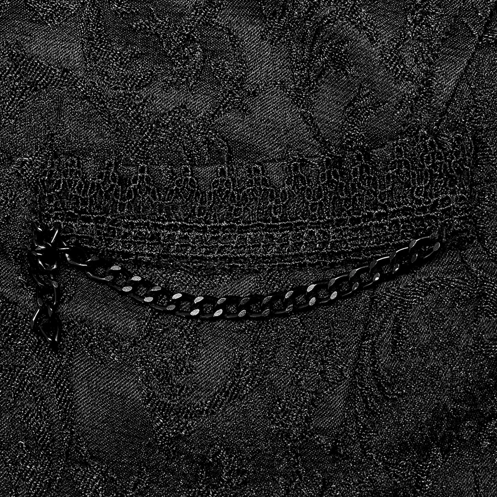 Gothic waistcoat pocket detail showing black metal chain trim and embroidered jacquard pattern close-up