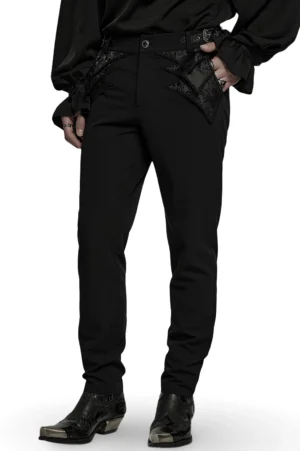 Black jacquard lace gothic trousers front three-quarter view on male model, showing asymmetrical lace embroidery details and fitted silhouette