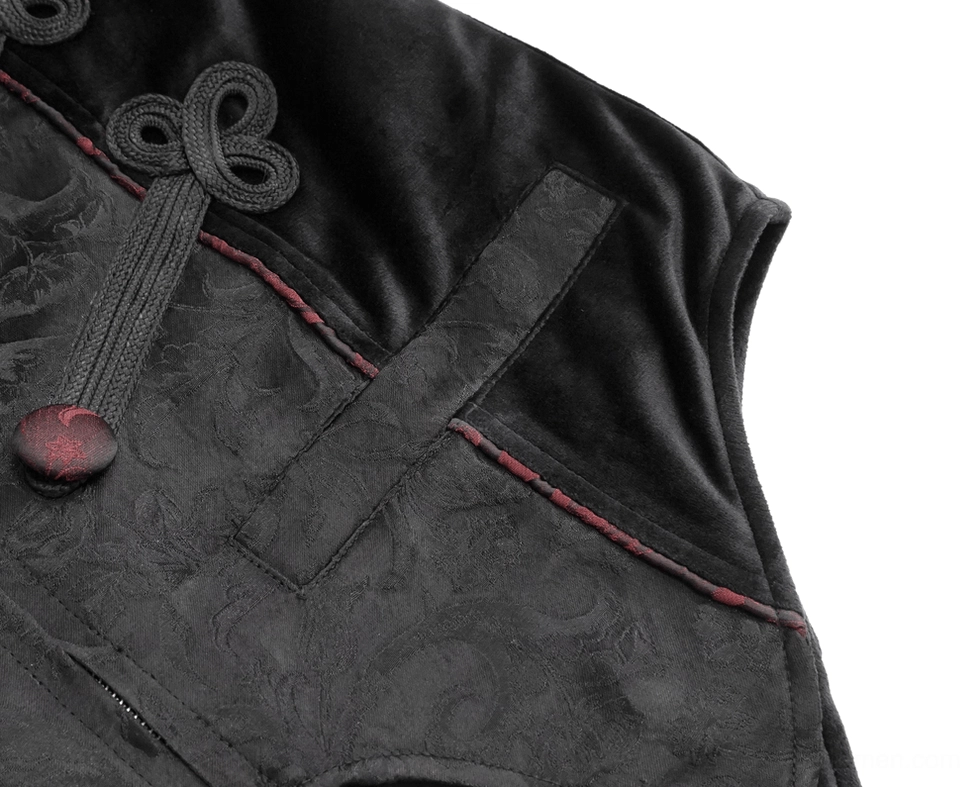 Close-up texture detail of black jacquard fabric with red frog fastener and red piping trim on gothic waistcoat