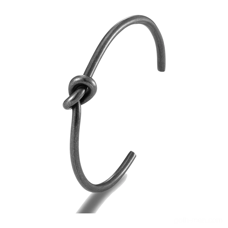 Black knotted open cuff gothic bracelet close-up side view showing twisted wire detail and matte oxidized finish