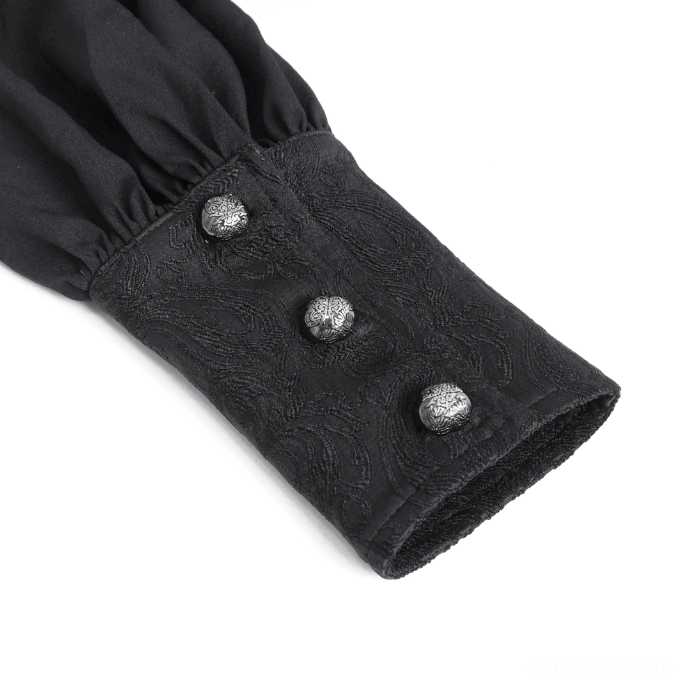 Close-up of black gothic shirt structured cuff with three metallic decorative buttons and gathered sleeve