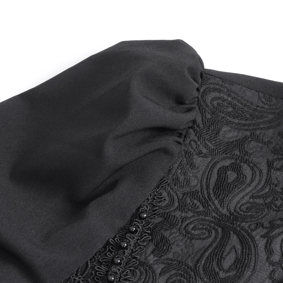 Detailed close-up of black lace gothic shirt front panel showing paisley embroidery and bead ruffle trim
