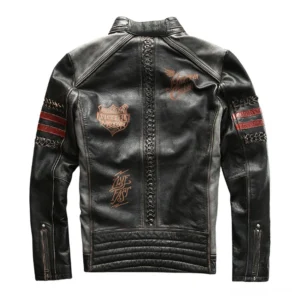 Black leather gothic jacket rear view showing quilted hem, back embroidered logos, zippered cuffs, and jacket construction details