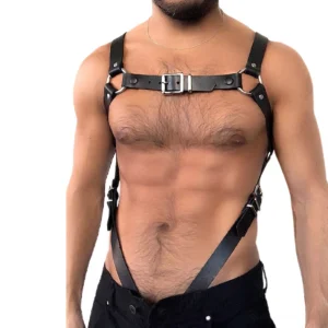 Black leather body harness with metal D-rings front view on shirtless male model showing chest buckles and adjustable straps