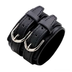 Black genuine leather gothic double-strap bracelet with silver metal toggle clasp, displaying smooth leather exterior and structured design from oblique angle