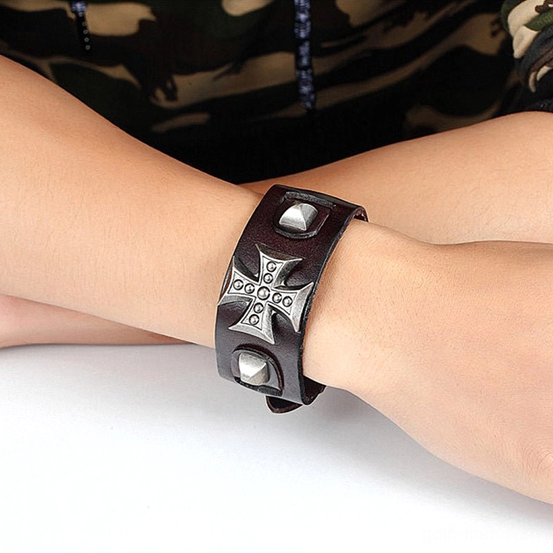 Black leather gothic cross bracelet angled side view with metal embellishments and adjustable toggle clasp mechanism