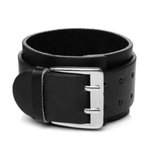 Black genuine leather gothic cuff bracelet with silver dual-pin buckle and adjustable perforated strap, front three-quarter studio view
