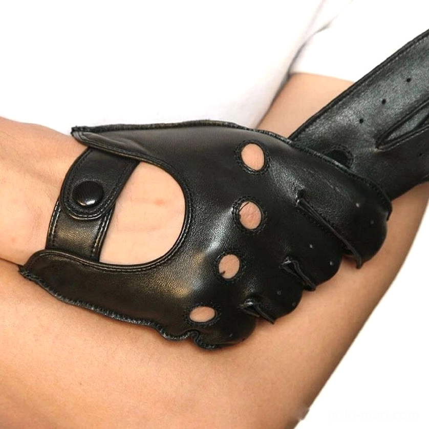 Side close-up of black leather gothic biker gloves worn on male forearm showing cutout ventilation pattern and wrist strap closure