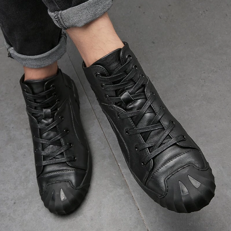 Black genuine leather high-top gothic sneaker artistic product shot highlighting monochromatic aesthetic