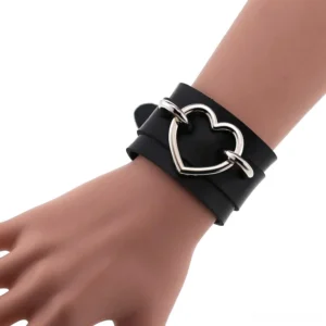 Black leather double-layer heart cuff bracelet with hollow iron heart buckle on mannequin wrist, side close-up view gothic bracelet