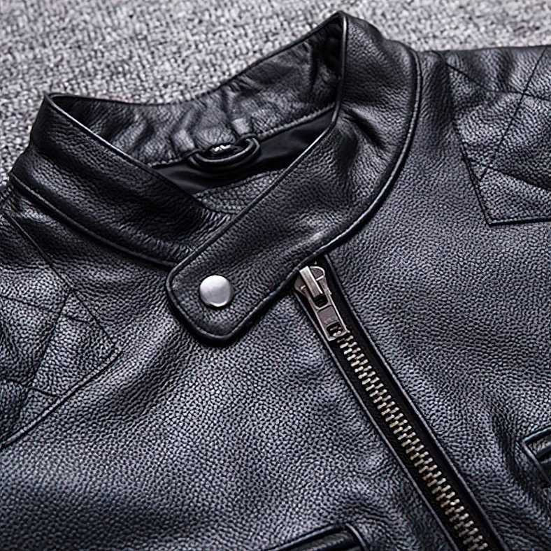 Close-up of black leather jacket snap button collar with pebbled calfskin texture detail