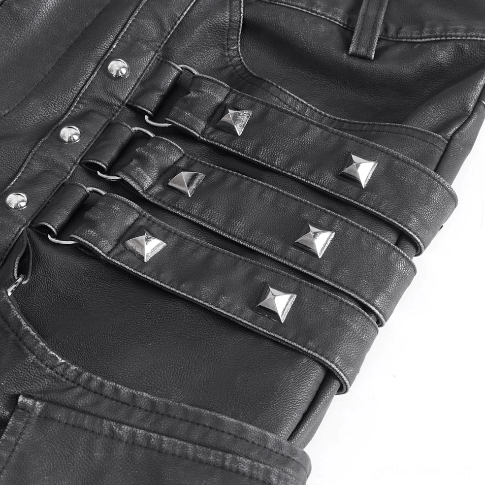 Macro detail of black leather pants showing pyramid studs, metal rivets, and pebbled synthetic leather texture