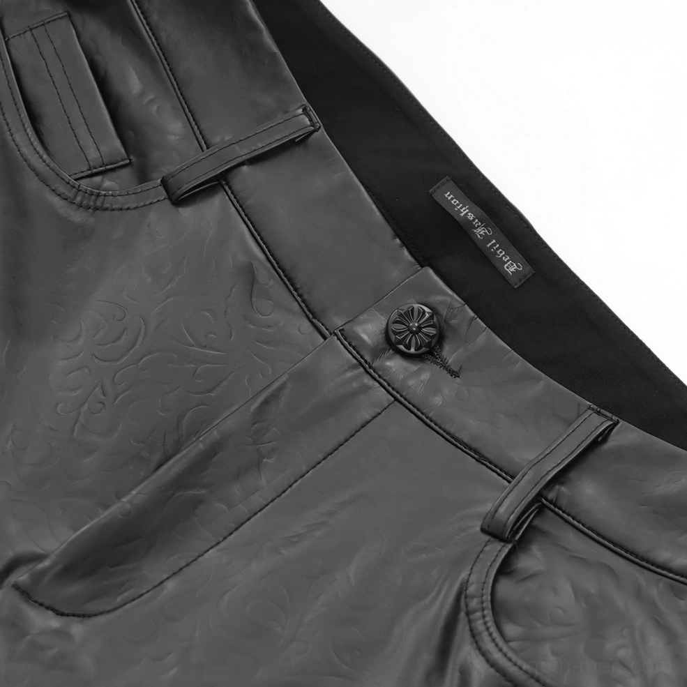 Close-up detail of black leather pants waist button embossed floral pattern and front pocket design