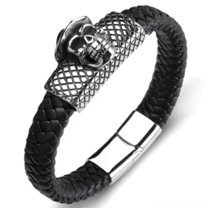 Black woven leather skull bracelet with silver magnetic clasp, overhead view on white background showing intricate grid pattern and skull charm