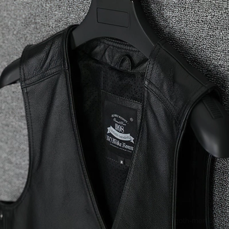 Close-up of gothic leather vest inner collar and neckline trim, showing mesh lining and leather construction details